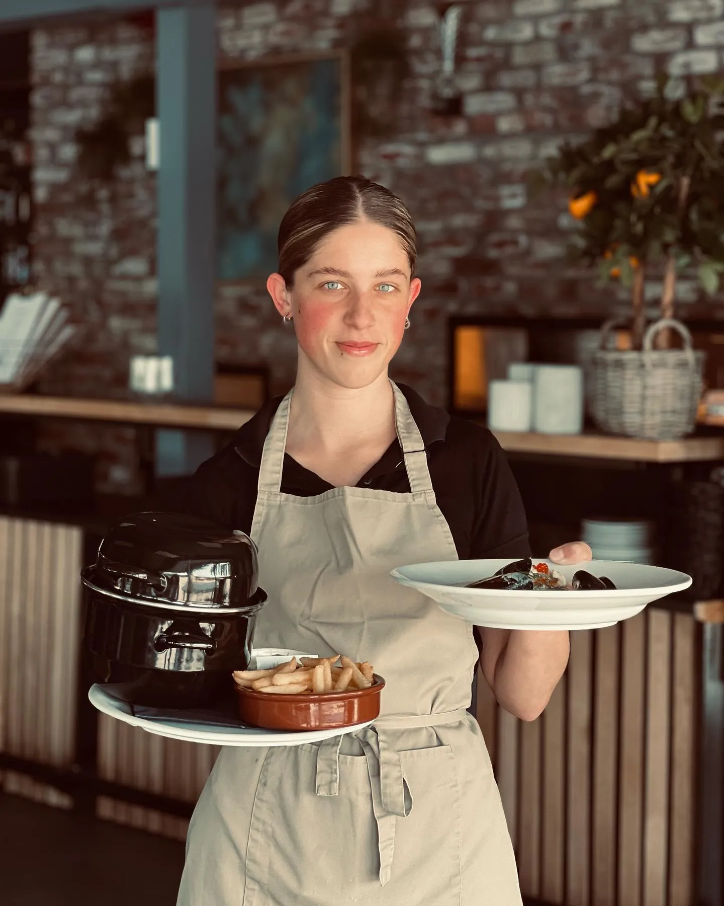 Servitør på Restaurant Vadskjæret, som leverer retter til kundene.